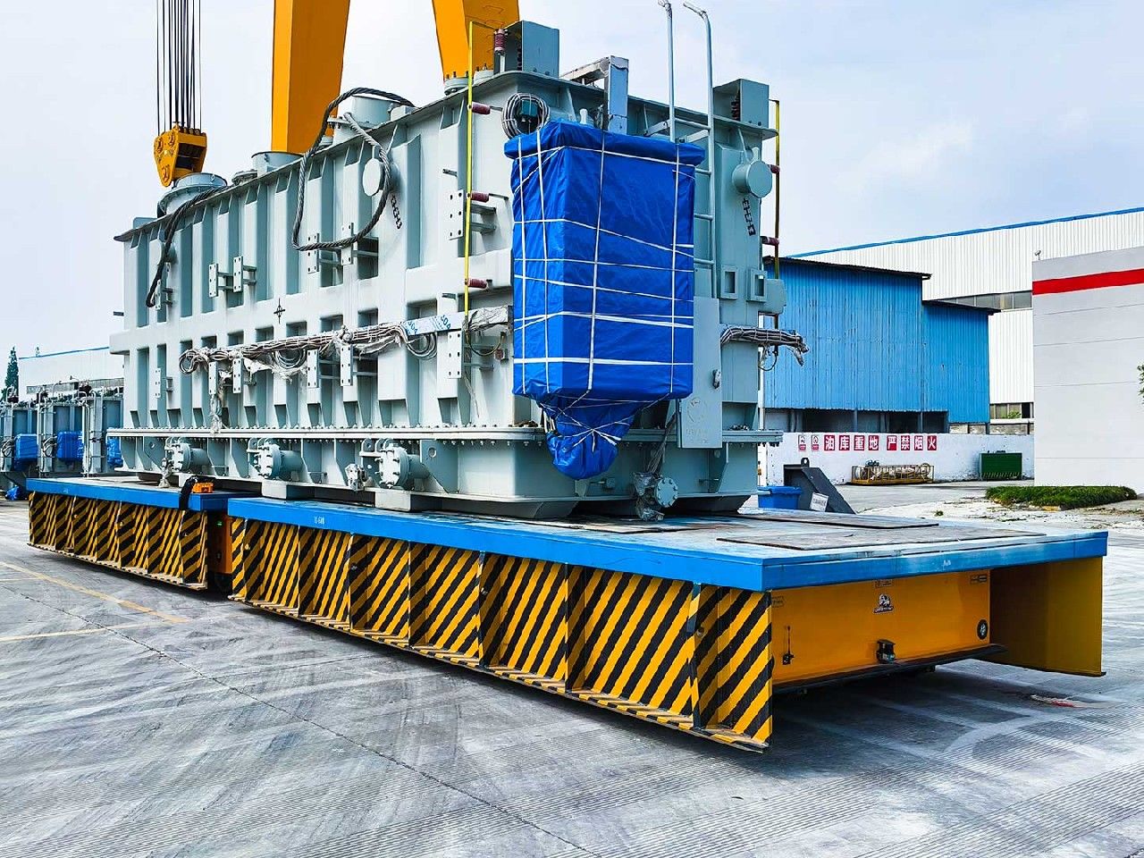 Semco Heavy Duty AGV transporting a large power transformer inside a manufacturing plant