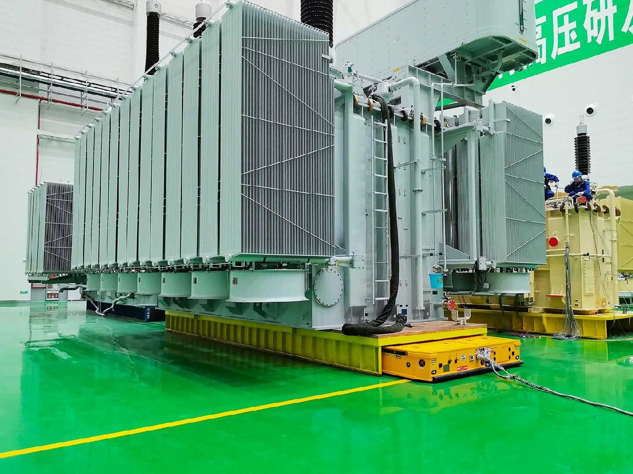 Heavy Duty AGV in operation across heavy engineering shop floor — omnidirectional material transfer
