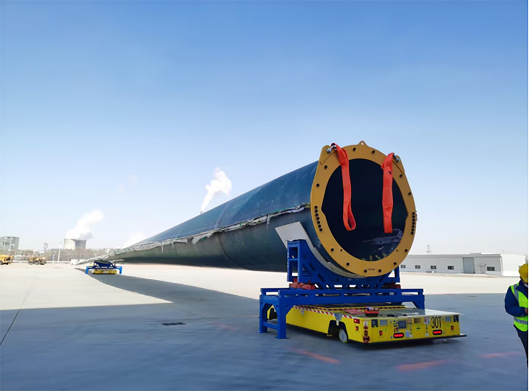 Heavy Duty AGV positioned under a large industrial load for under-roll lifting
